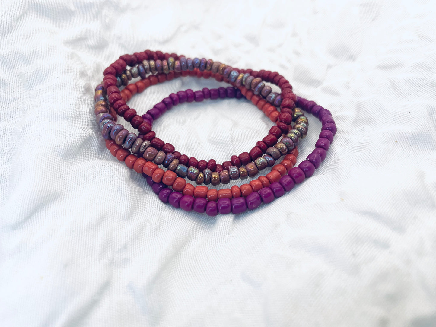 Magenta bracelet stack, maroon bracelets