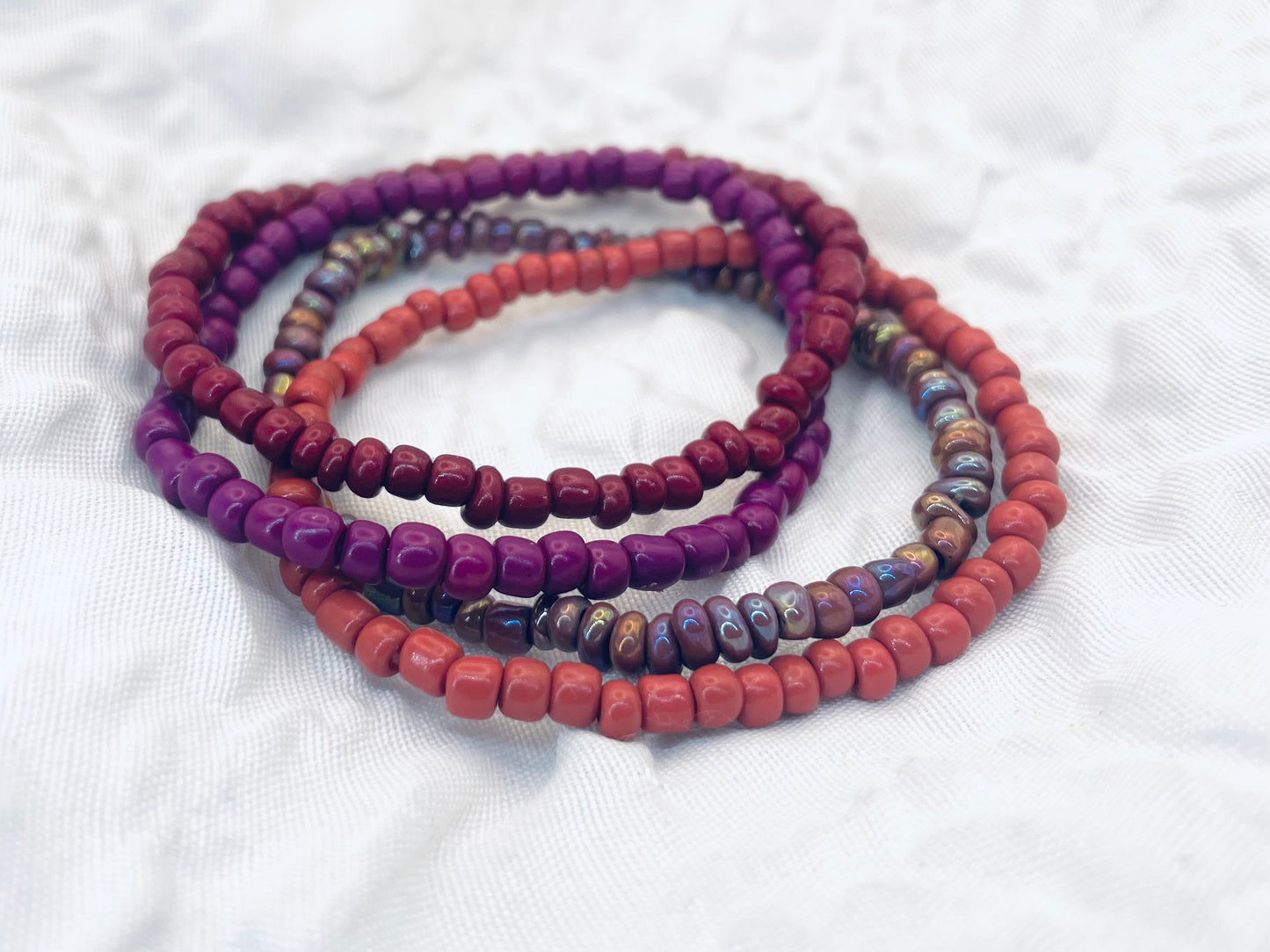 Magenta bracelet stack, maroon bracelets