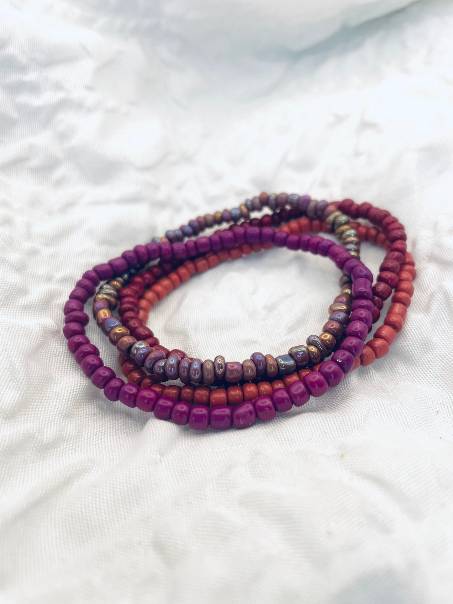 Magenta bracelet stack, maroon bracelets
