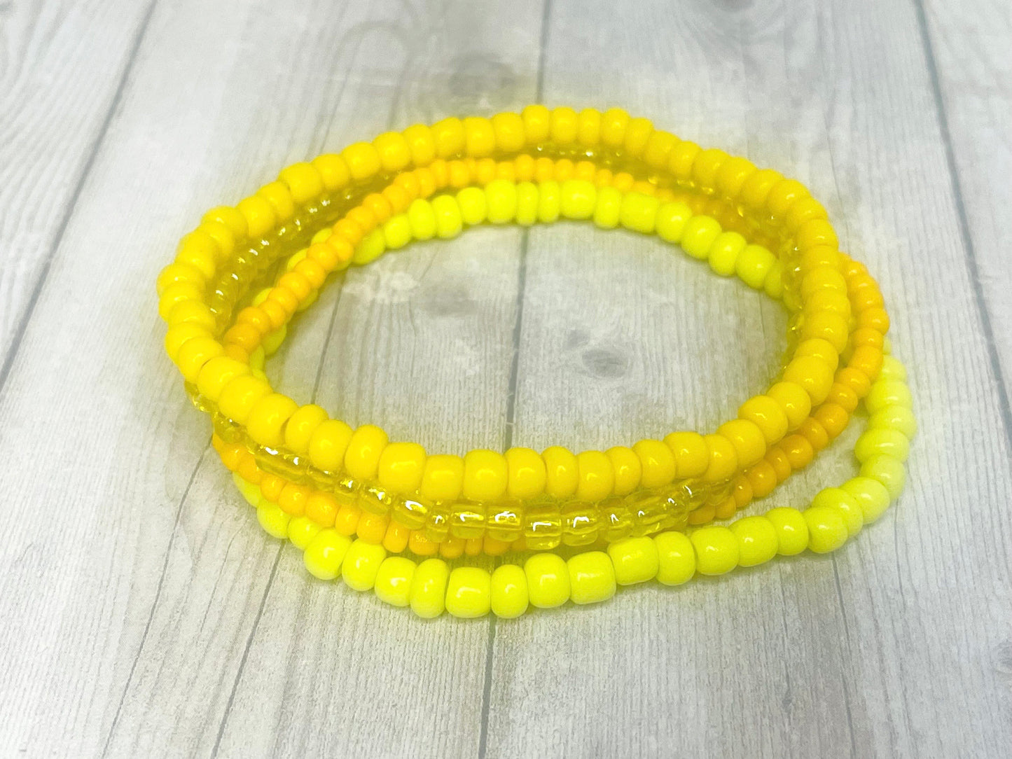 Yellow color stacked bracelets
