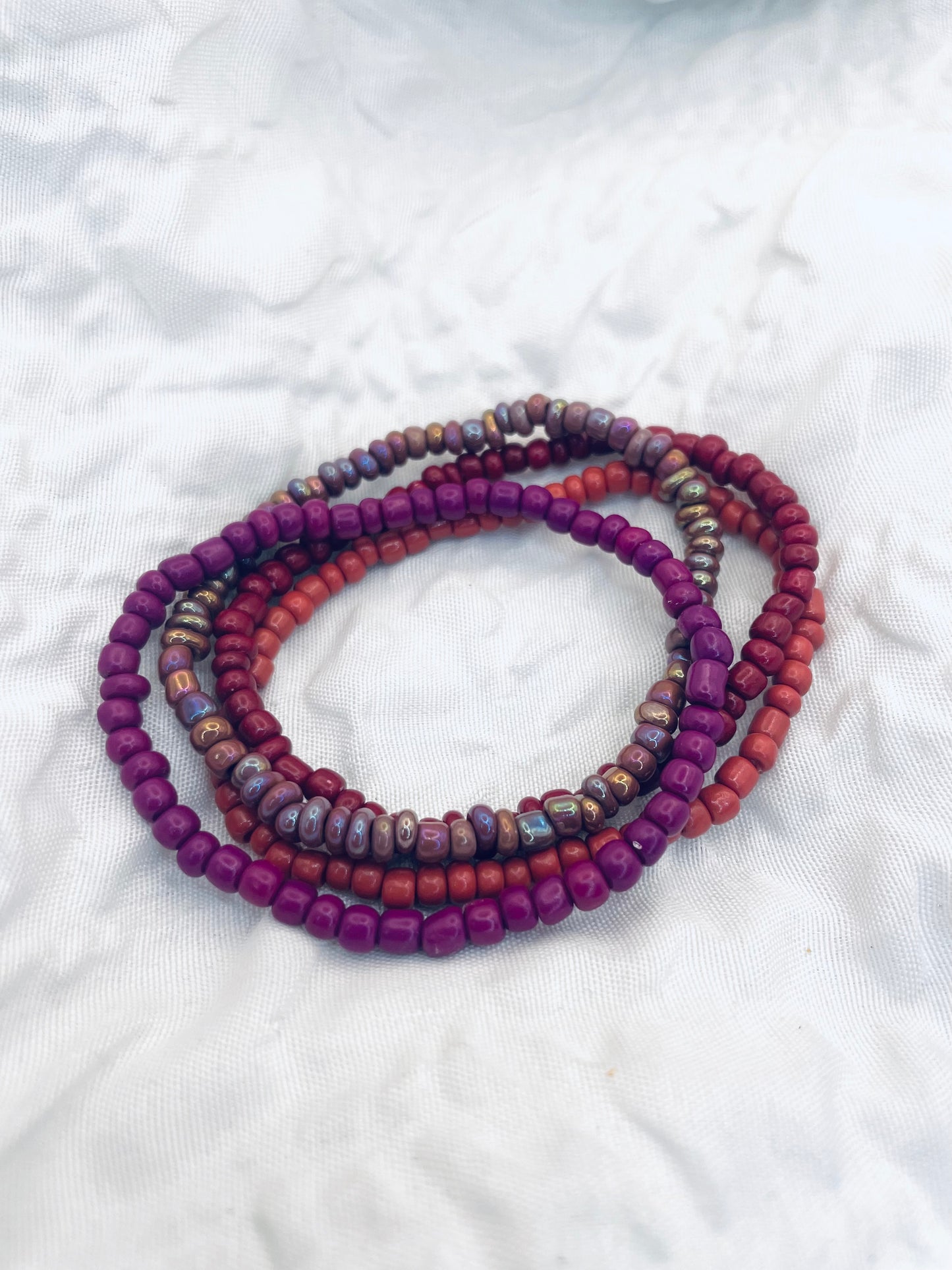 Magenta bracelet stack, maroon bracelets