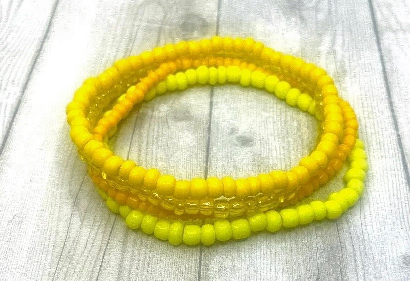 Yellow color stacked bracelets