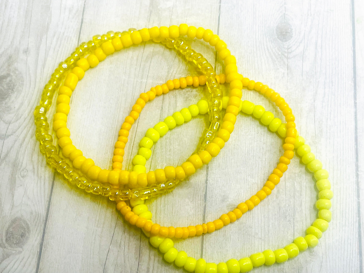 Yellow color stacked bracelets