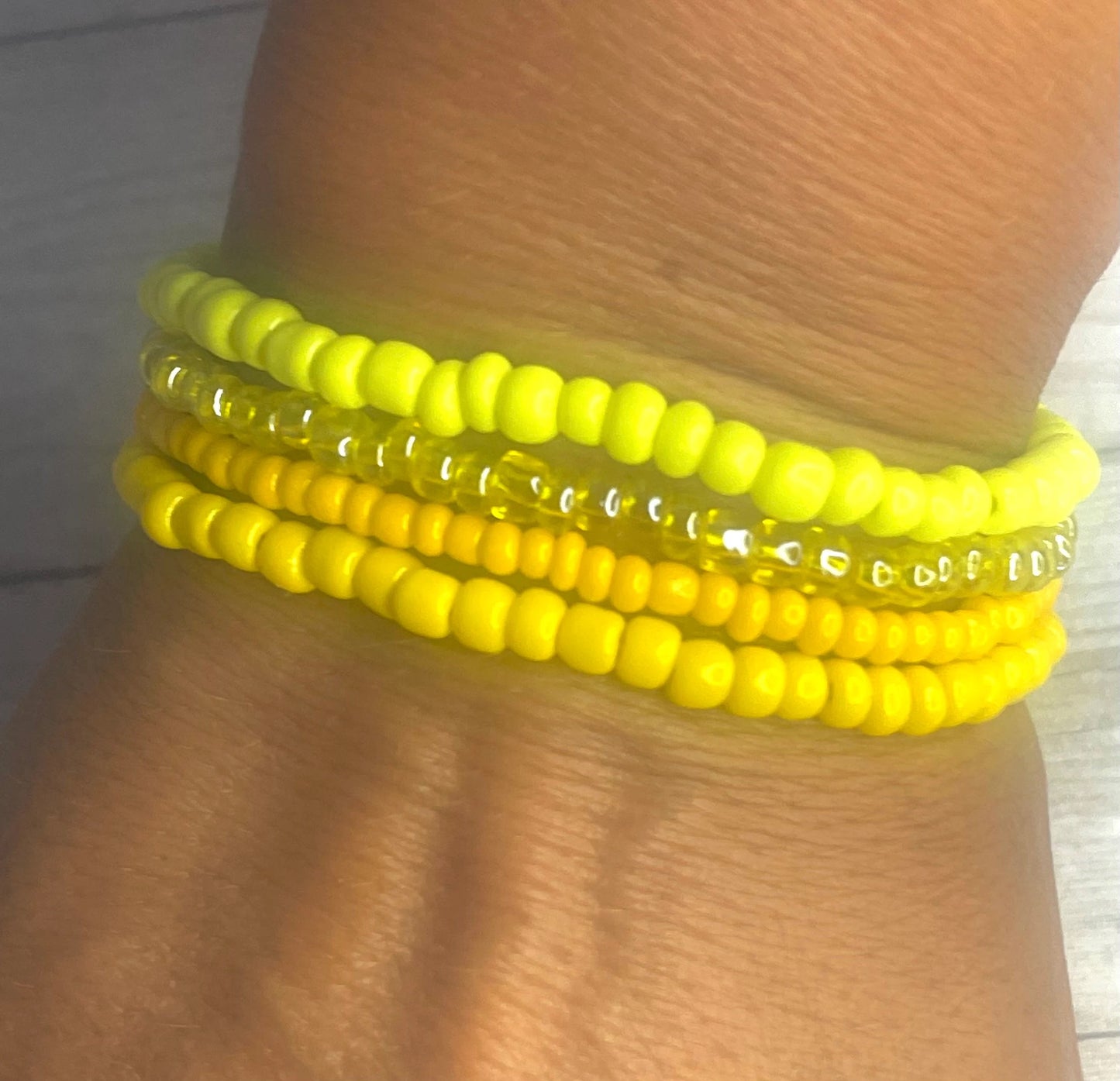 Yellow color stacked bracelets