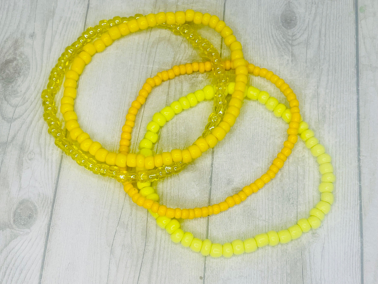 Yellow color stacked bracelets