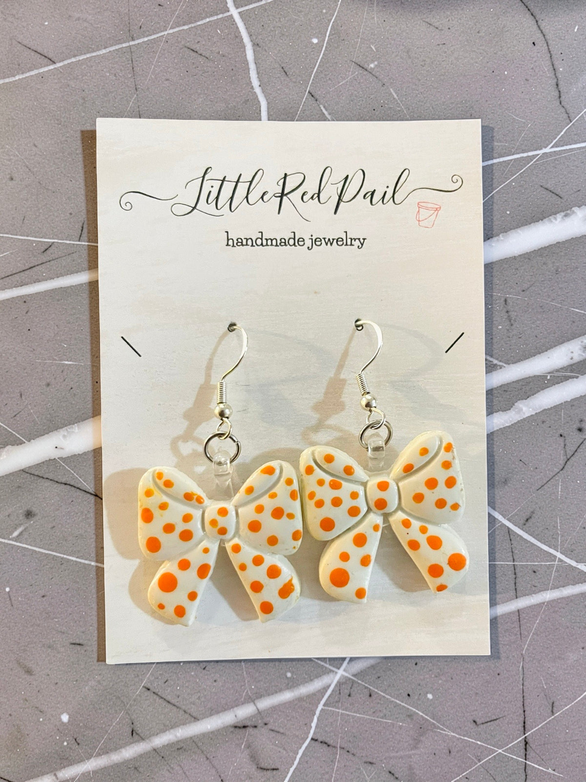 Orange and white game day bow earrings