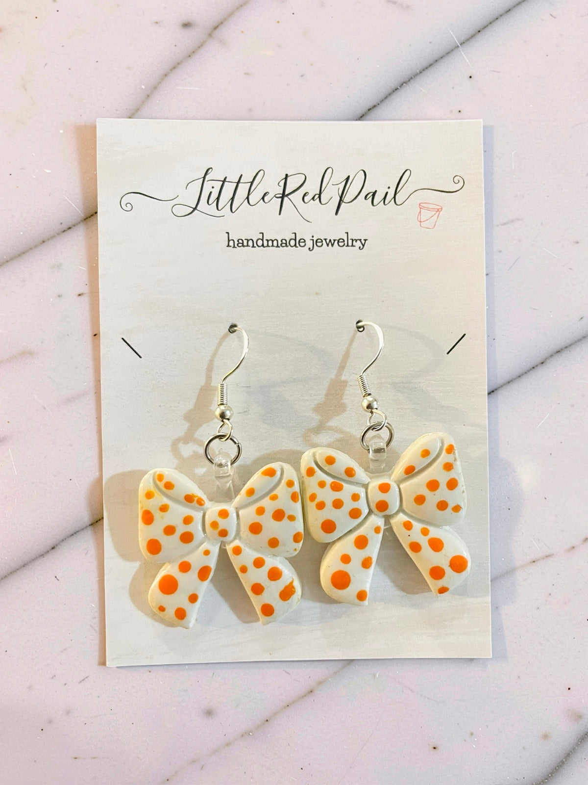 Orange and white game day bow earrings