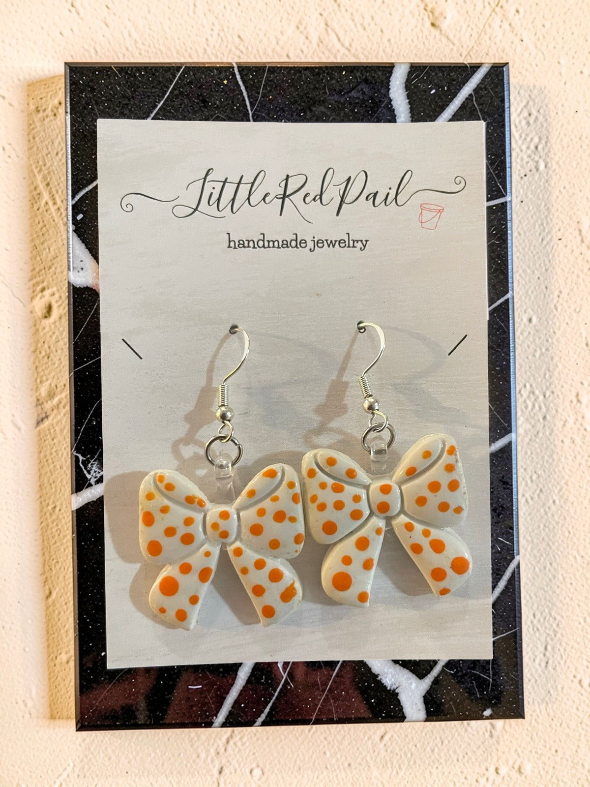 Orange and white game day bow earrings